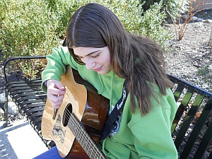 Mary with her guitar.